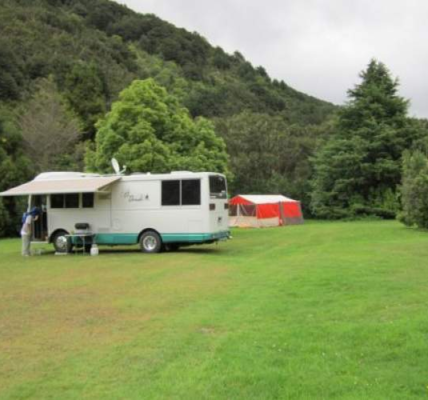 A camping van stands in a field